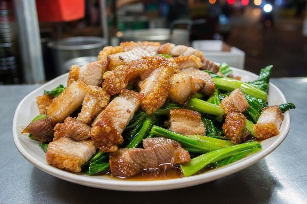 Pad Pak Kana Moo Krob Crispy Pork Broccoli, plated and ready to serve